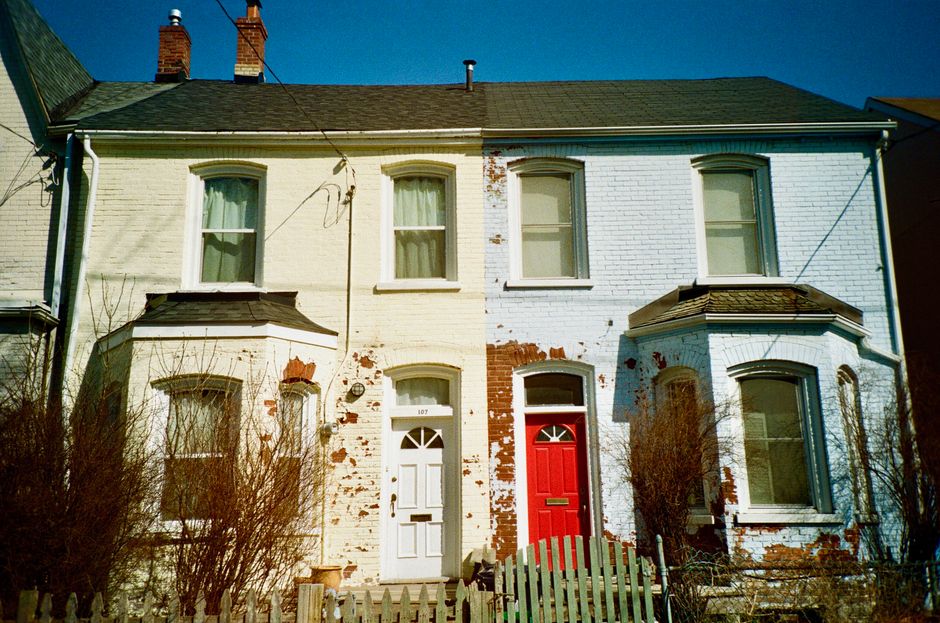 Brick houses with red and white painted doors.